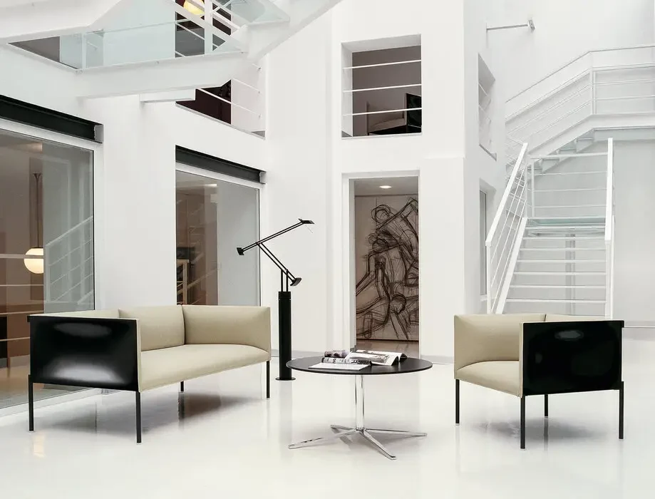 A sofa and two armchairs around a low table, wide format