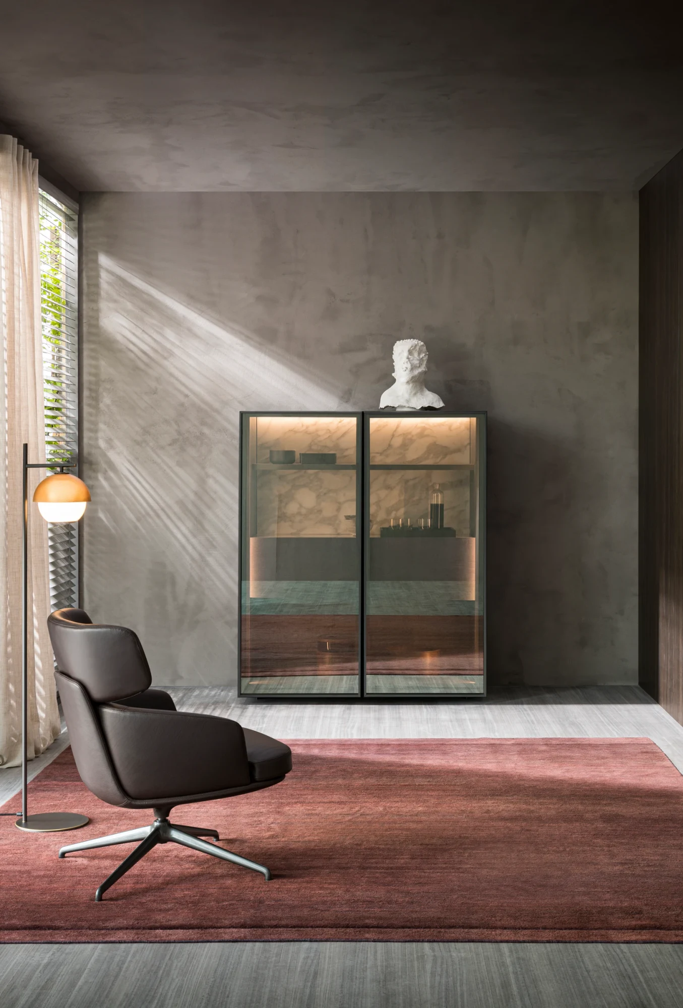 Cabinet with two glass doors beside an armchair in a room