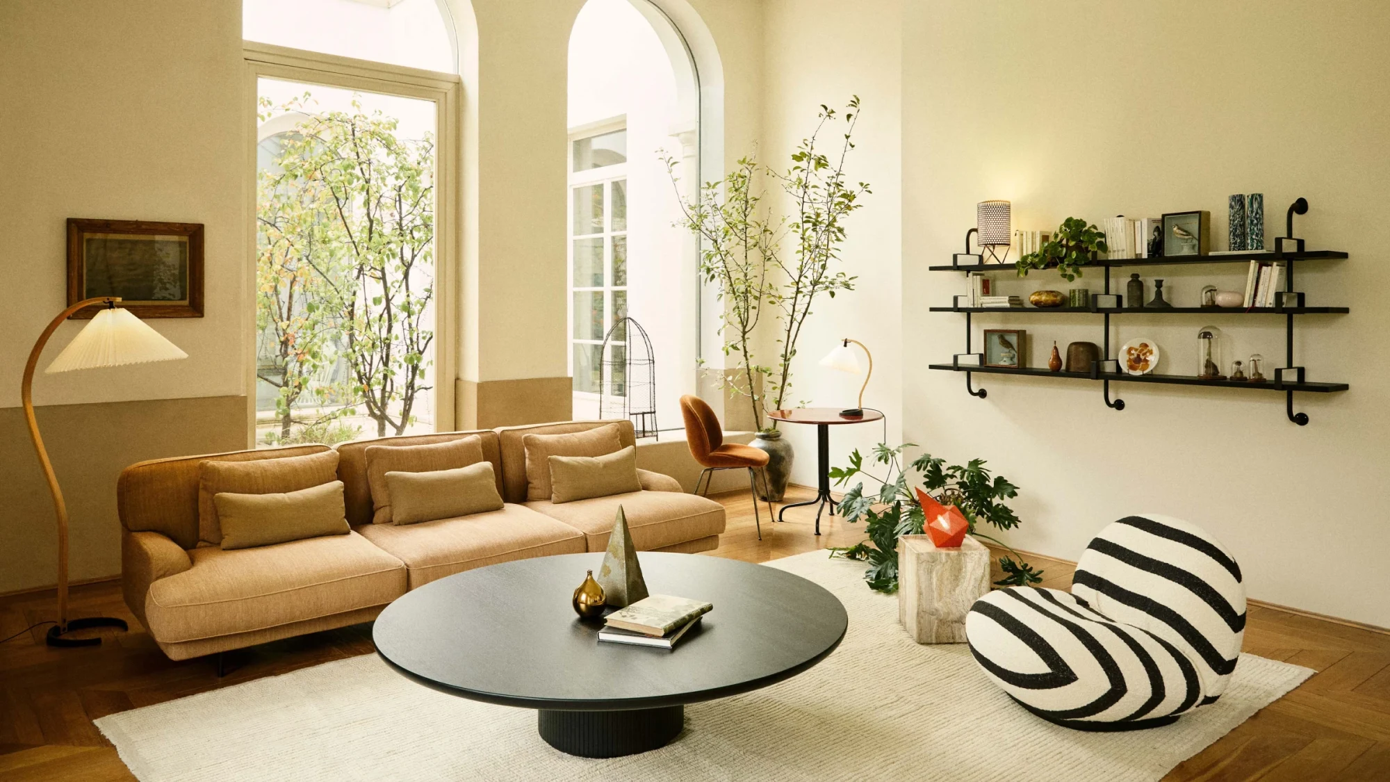Large low round table with a dark top in the foreground of a living room