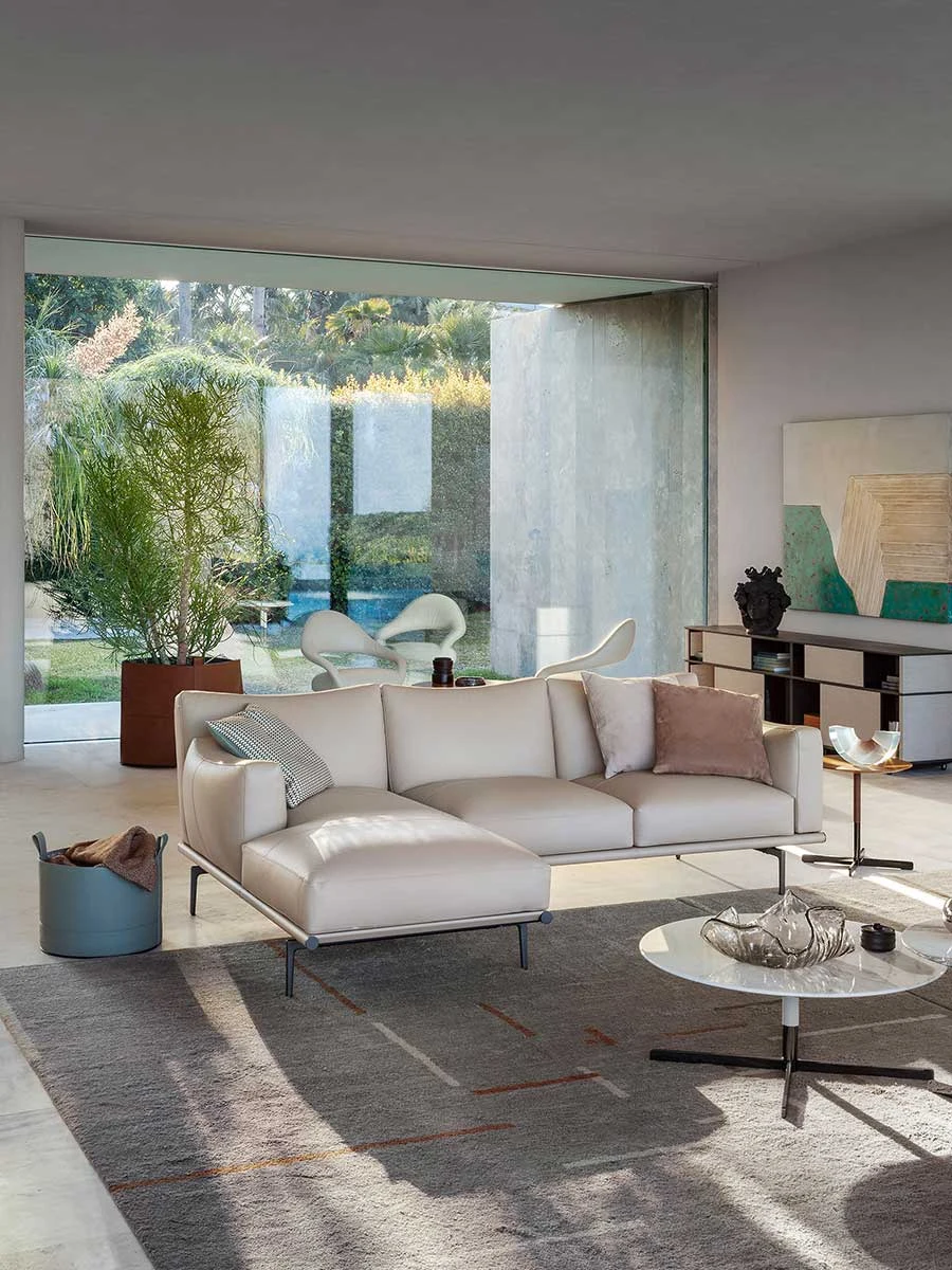 Sofa with a chaise end in a living room with large windows