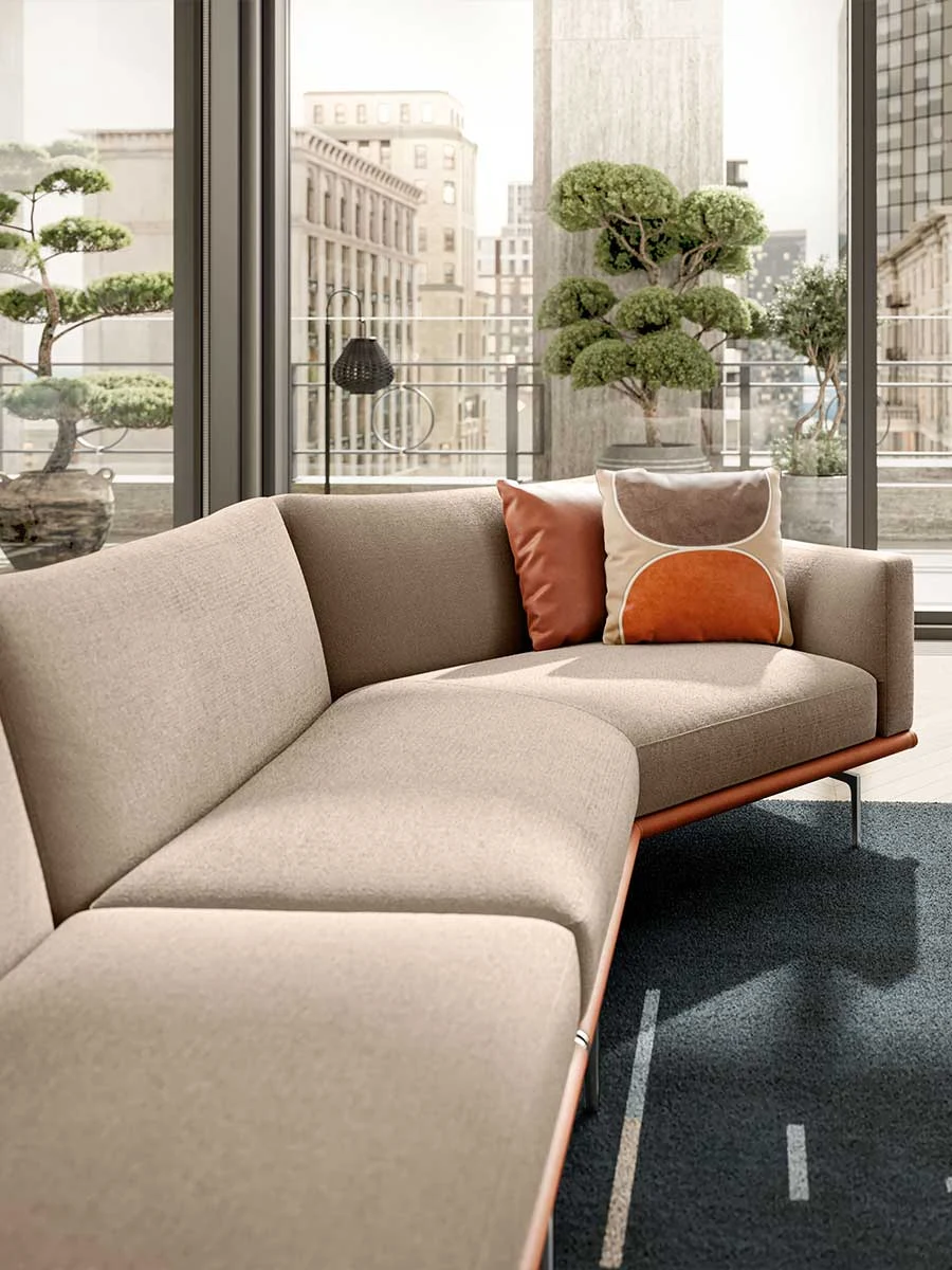 Angled corner sofa seen from the seat side, in front of a tall window