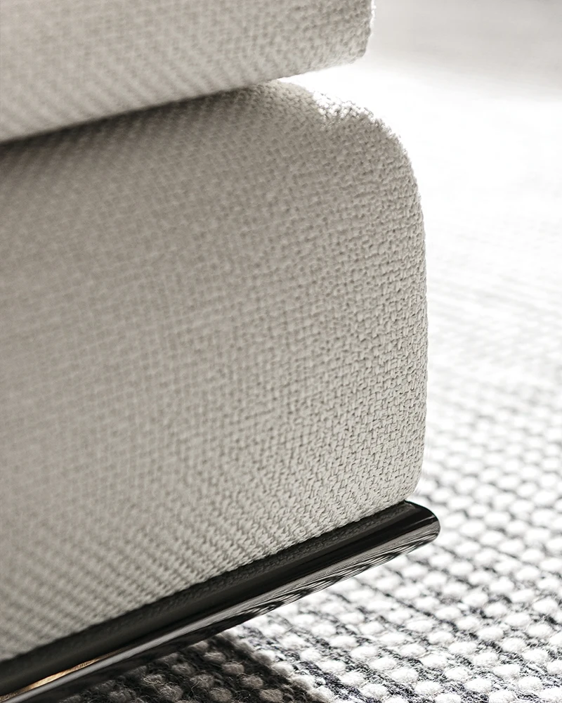 Corner detail of the fabric upholstery and metal base, official Minotti photo