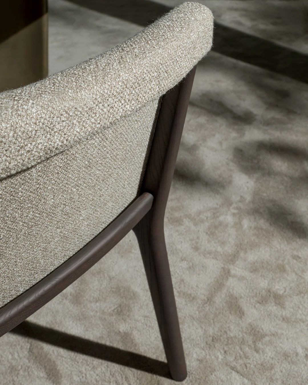 Close view of the back and a rear leg of a Janet chair