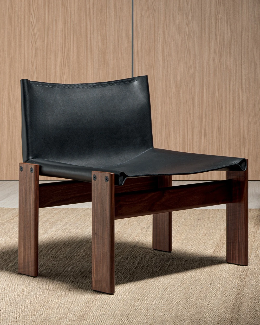 Monk armchair against a plain wall on a woven rug