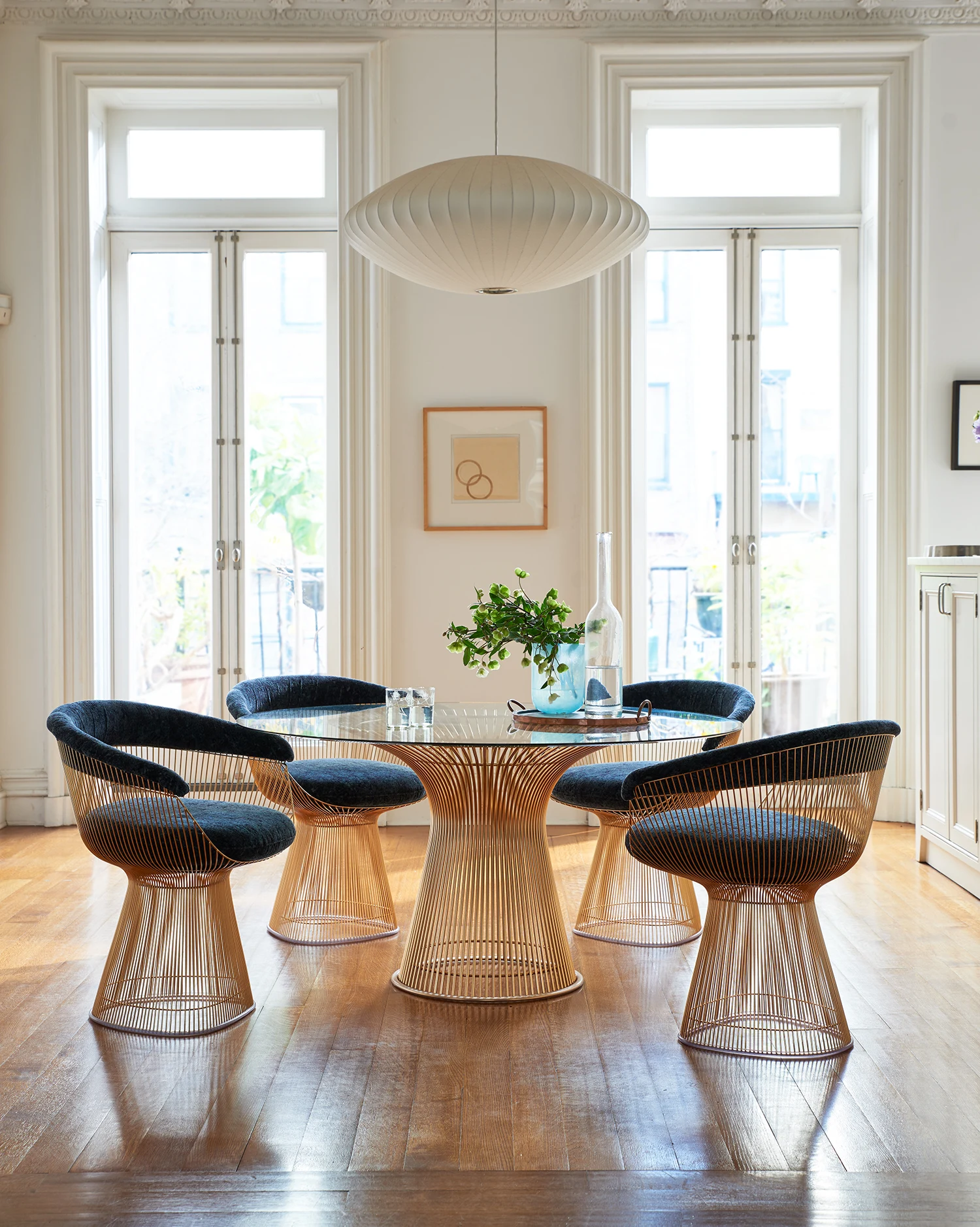 Round table with four Platner arm chairs, 18k gold-plated finish (official Knoll photograph, caption 12673 Platner Collection with 18k Gold-Plated Finish)