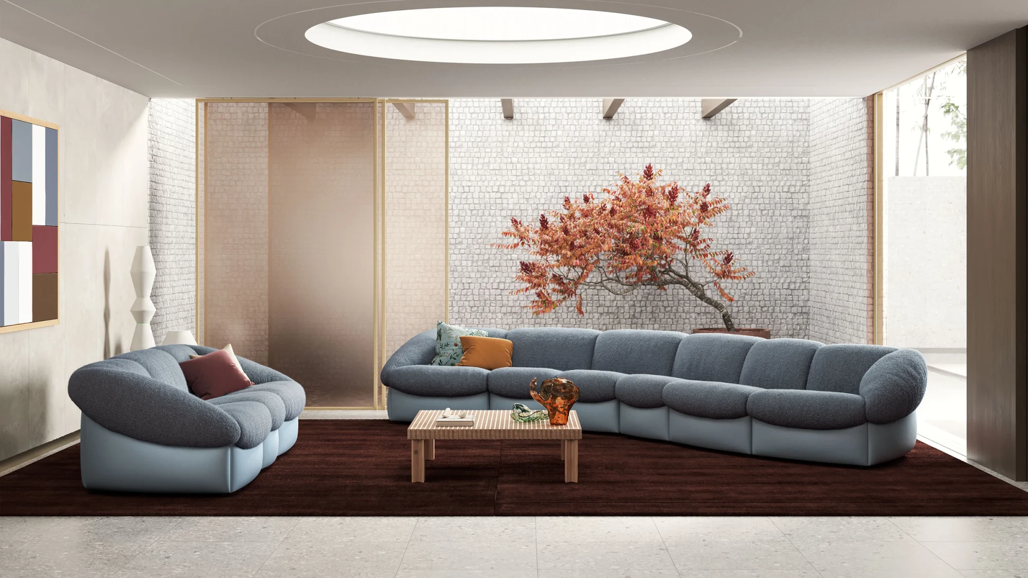 Grey sofas with rounded backs and a low table on a dark rug in a hall with a round skylight
