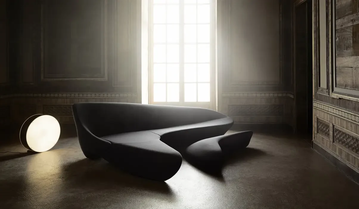 A sofa with a separate low element in front of it, wide format