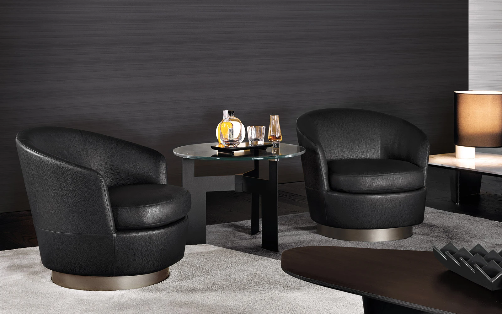Two low armchairs, official Minotti photo